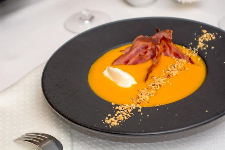 Pumpkin Cream Soup with Bacon and Crushed Pine Nuts